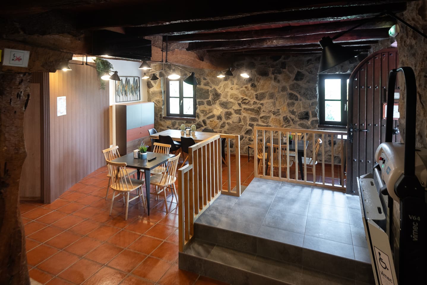 Common dining room with platform adapted for wheelchair in the rural house Artola